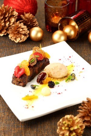 Christmas pudding with confit orange supreme, brandy custard and vanilla ice cream